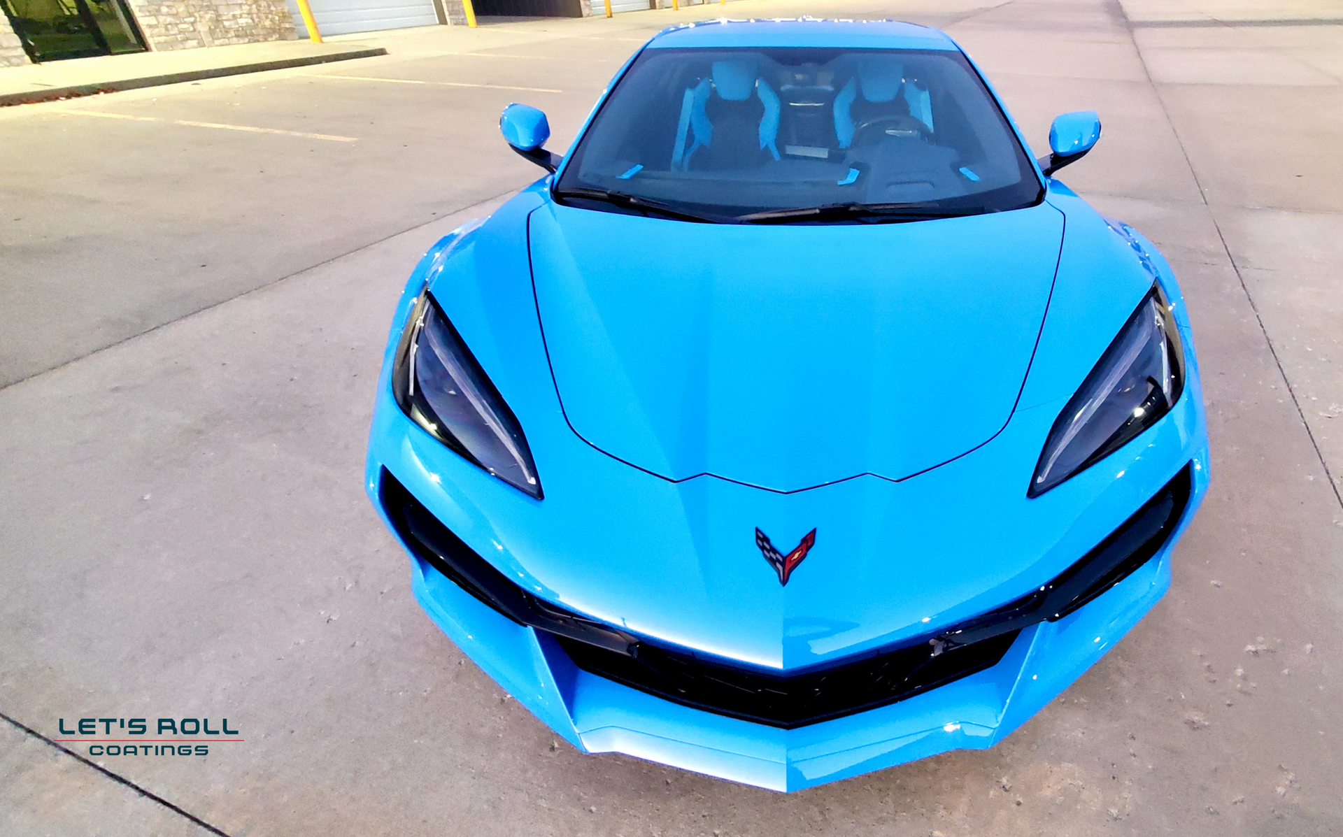 A blue sports car is parked on the side of the road