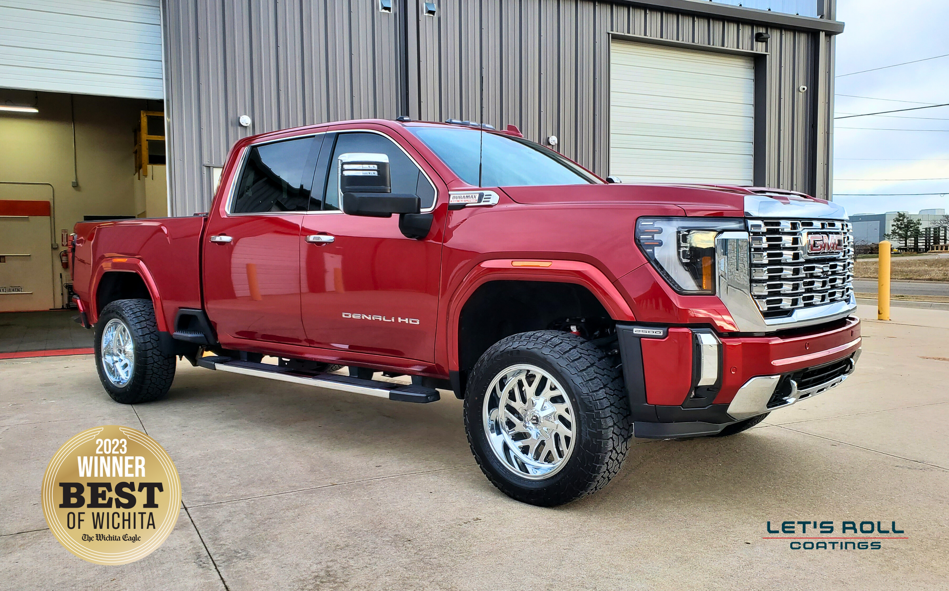 A red pickup truck is parked in front of a building.