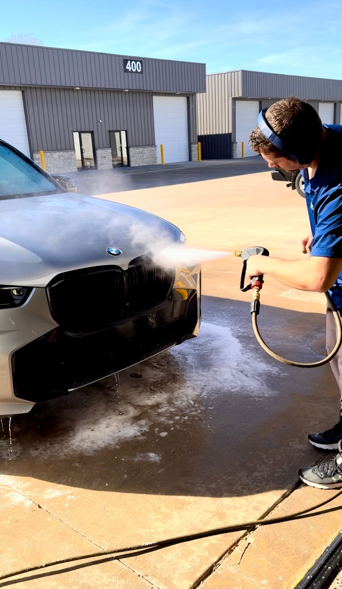 a professional washing a ceramic-coated car