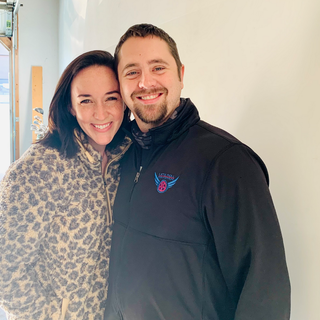 A man and a woman are posing for a picture together . the woman is wearing a leopard print jacket.