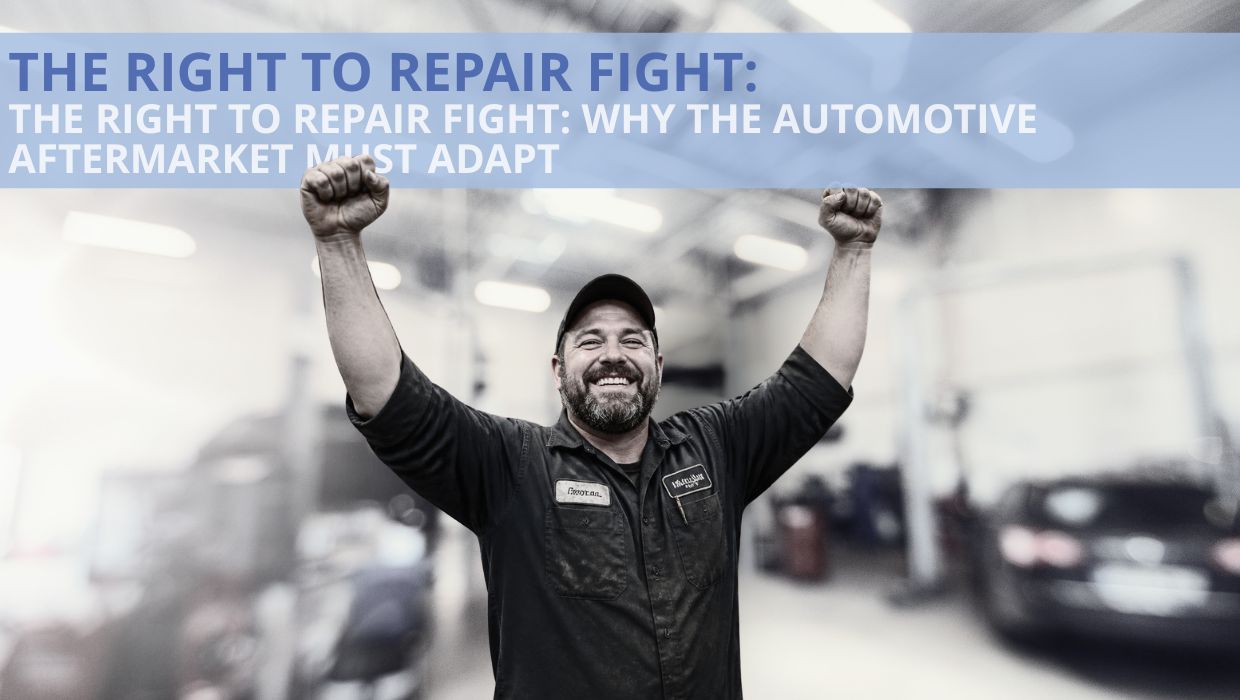 A smiling automotive technician in a repair shop raises both fists beneath a banner.