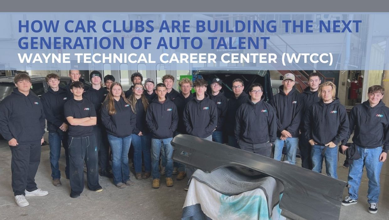 Students in Wayne Technical Career Center auto shop posing in hoodies around car body panel