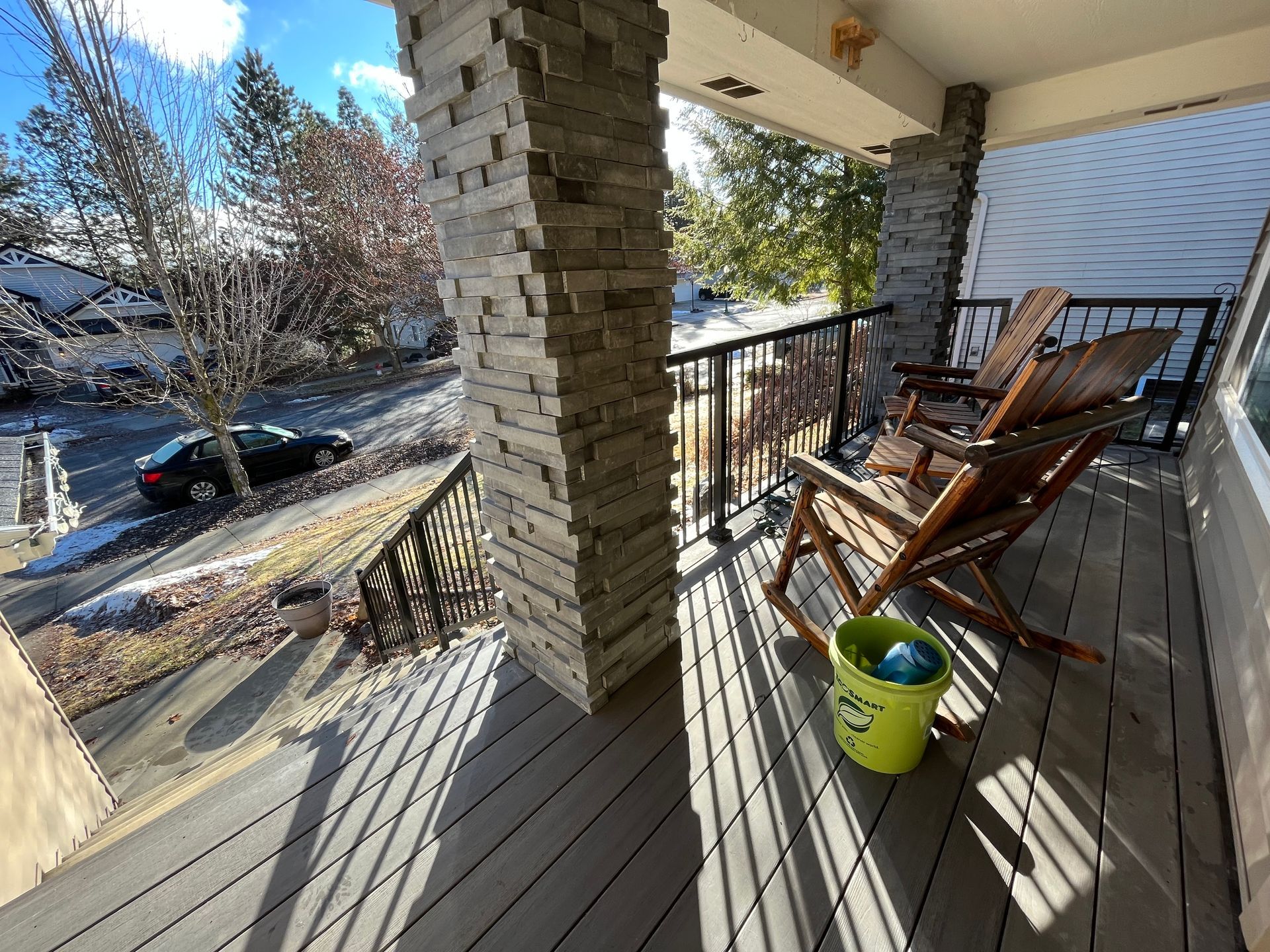 There is a Large Deck With a Pergola and Chairs on It