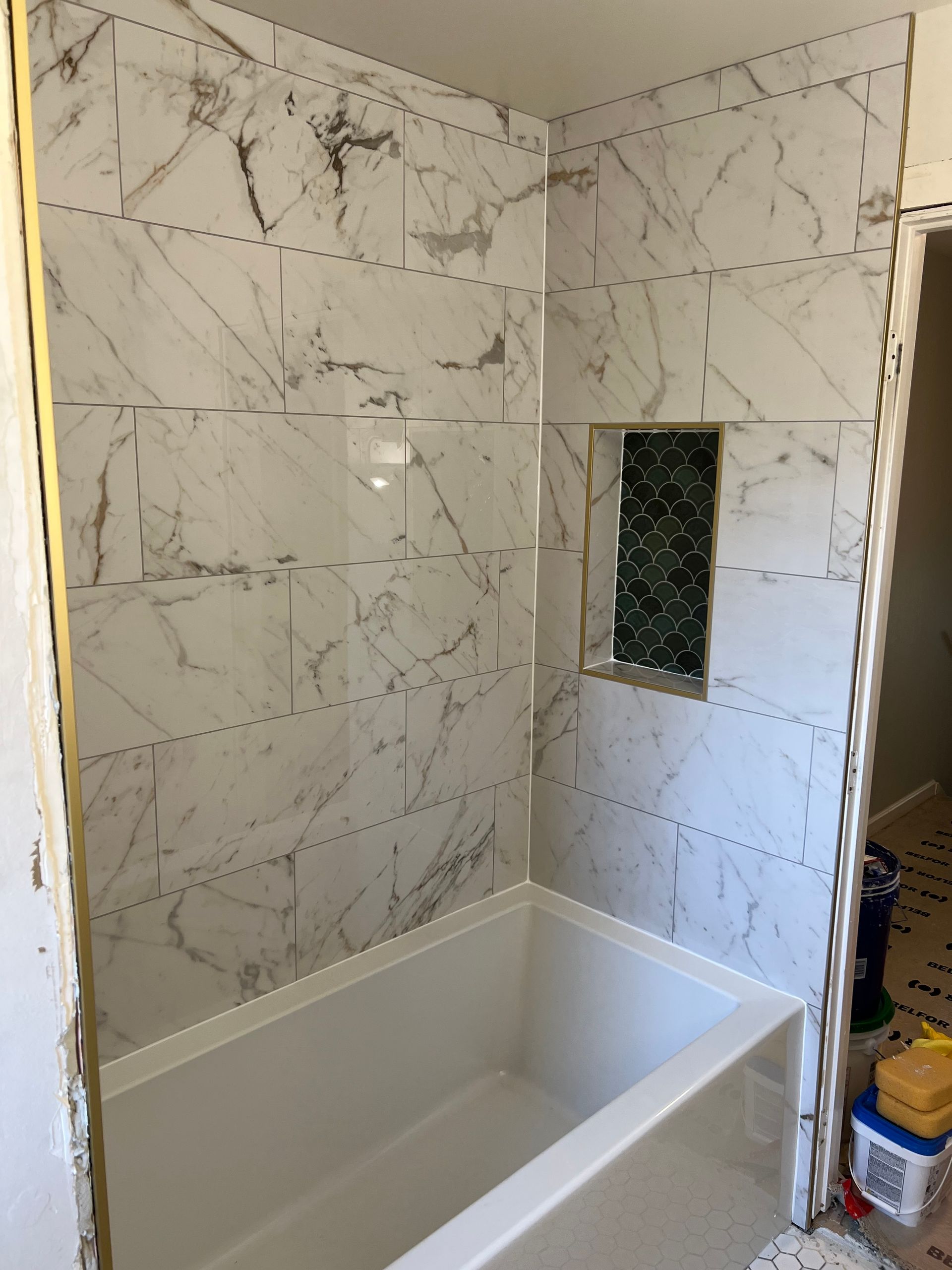 A Bathroom With Marble Tiles and a Bathtub