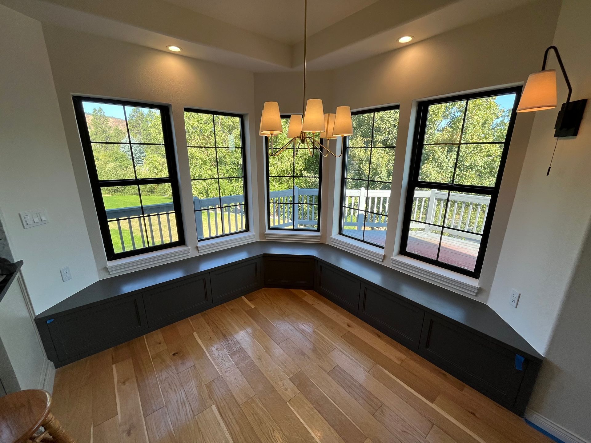 Room With a Lot of Windows and a Chandelier Hanging From the Ceiling