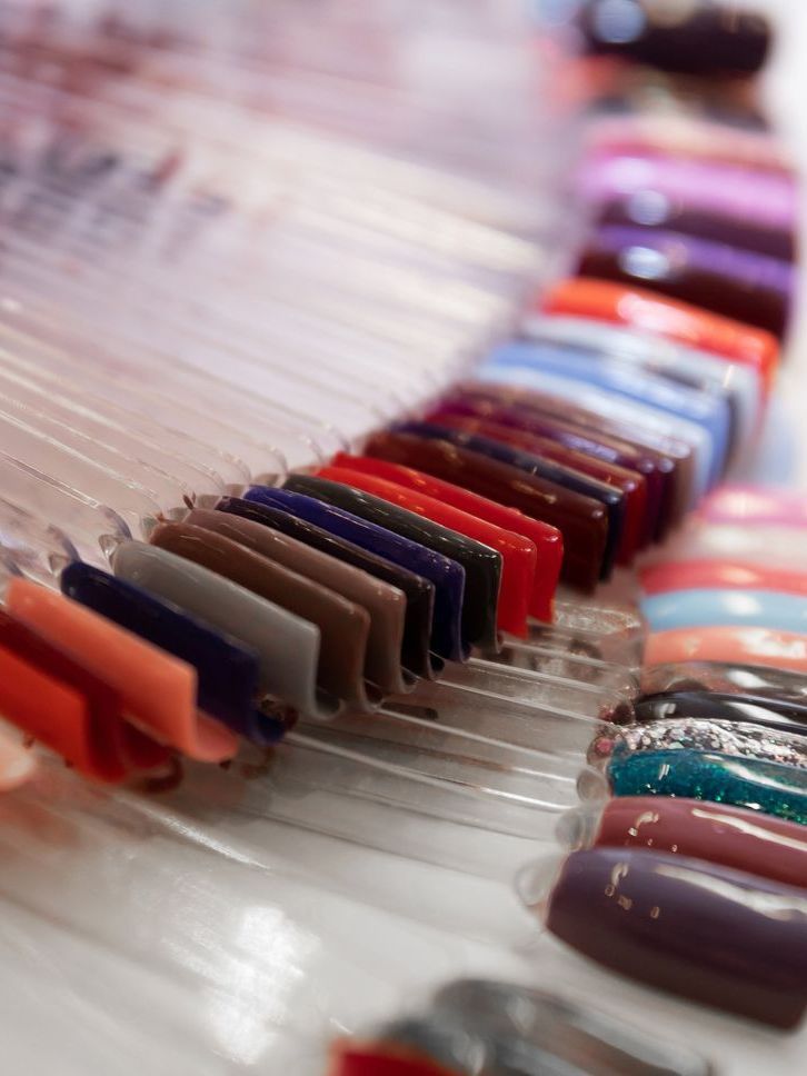 A bunch of different colored nails are sitting on a table.