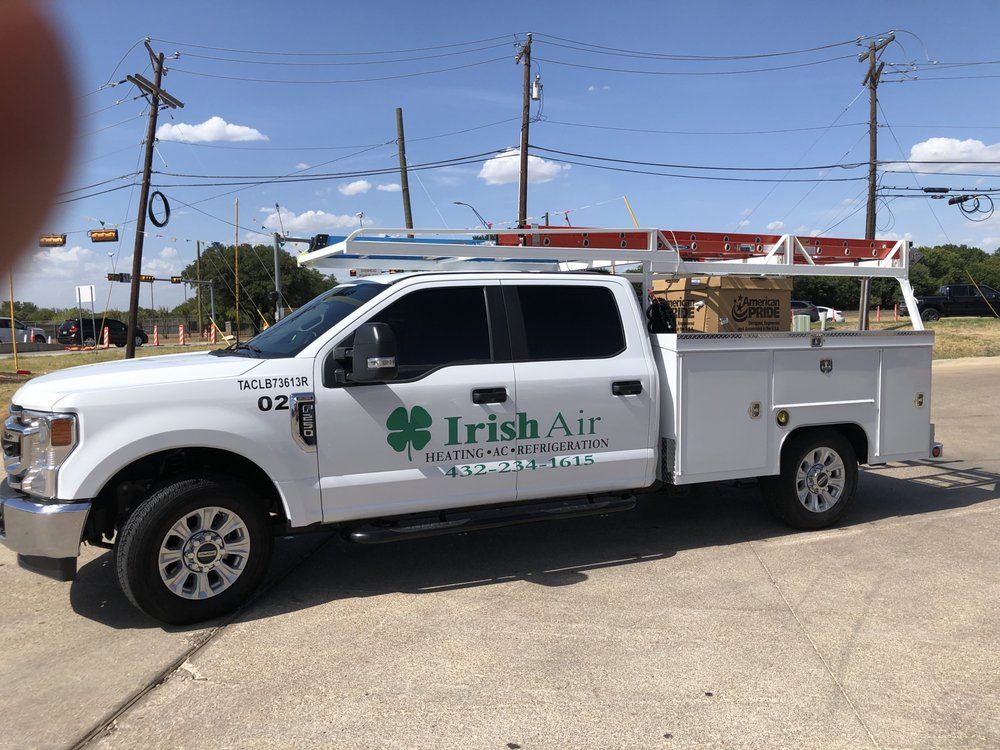 A white irish air truck is parked on the side of the road.