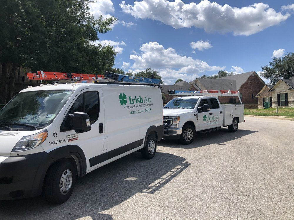 Two irish air vans are parked on the side of the road.