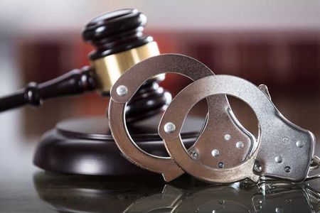Close-up Of Handcuffs And Gavel 