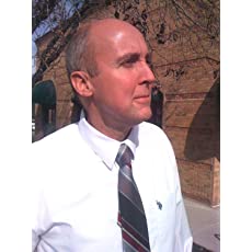 A man in a white shirt and tie is standing in front of a building.