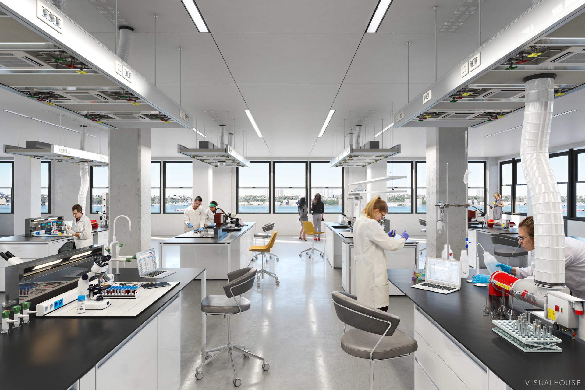 A bright, modern laboratory with scientists at work. White countertops, equipment, and windows overlooking a cityscape.