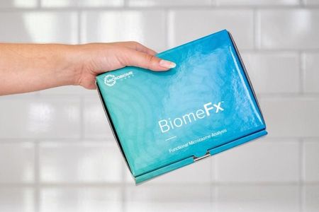 Hand holding a blue and teal