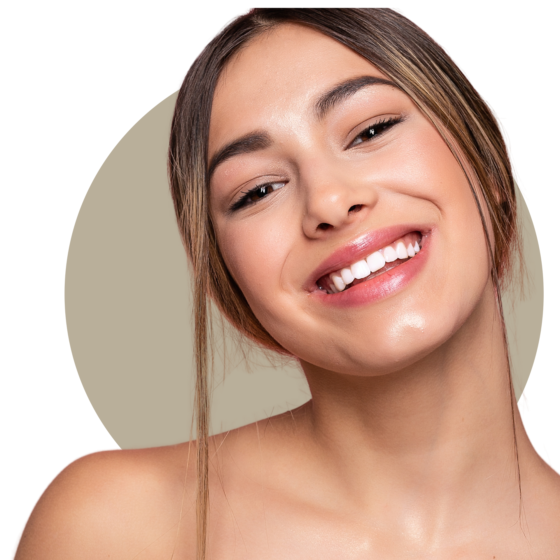 A woman with long curly hair is smiling and touching her face.