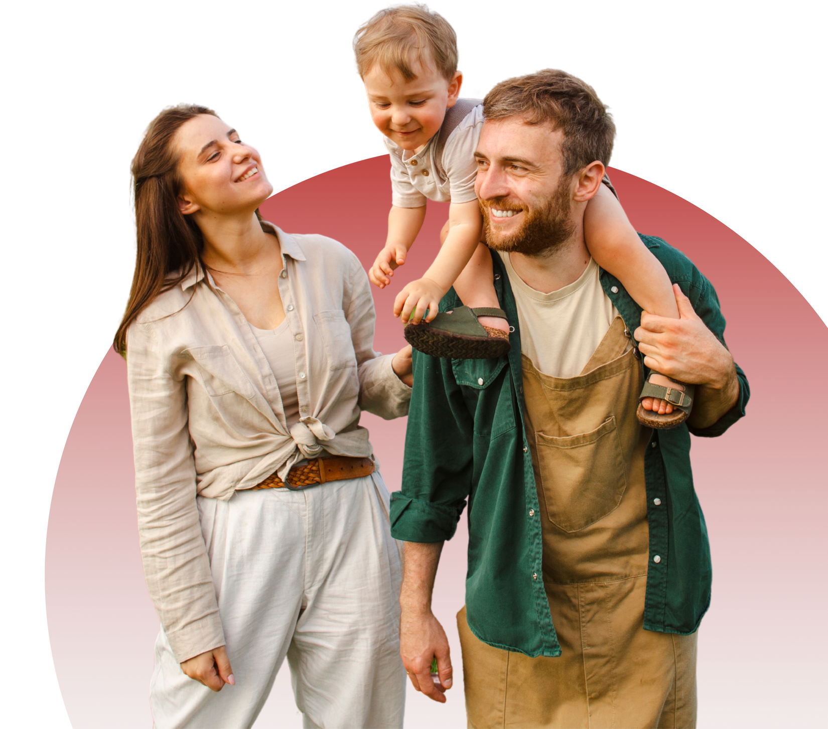 A man is carrying a child on his shoulders while a woman looks on.