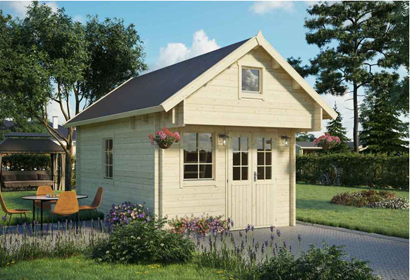 A small white house with a black roof is sitting in the middle of a lush green yard.