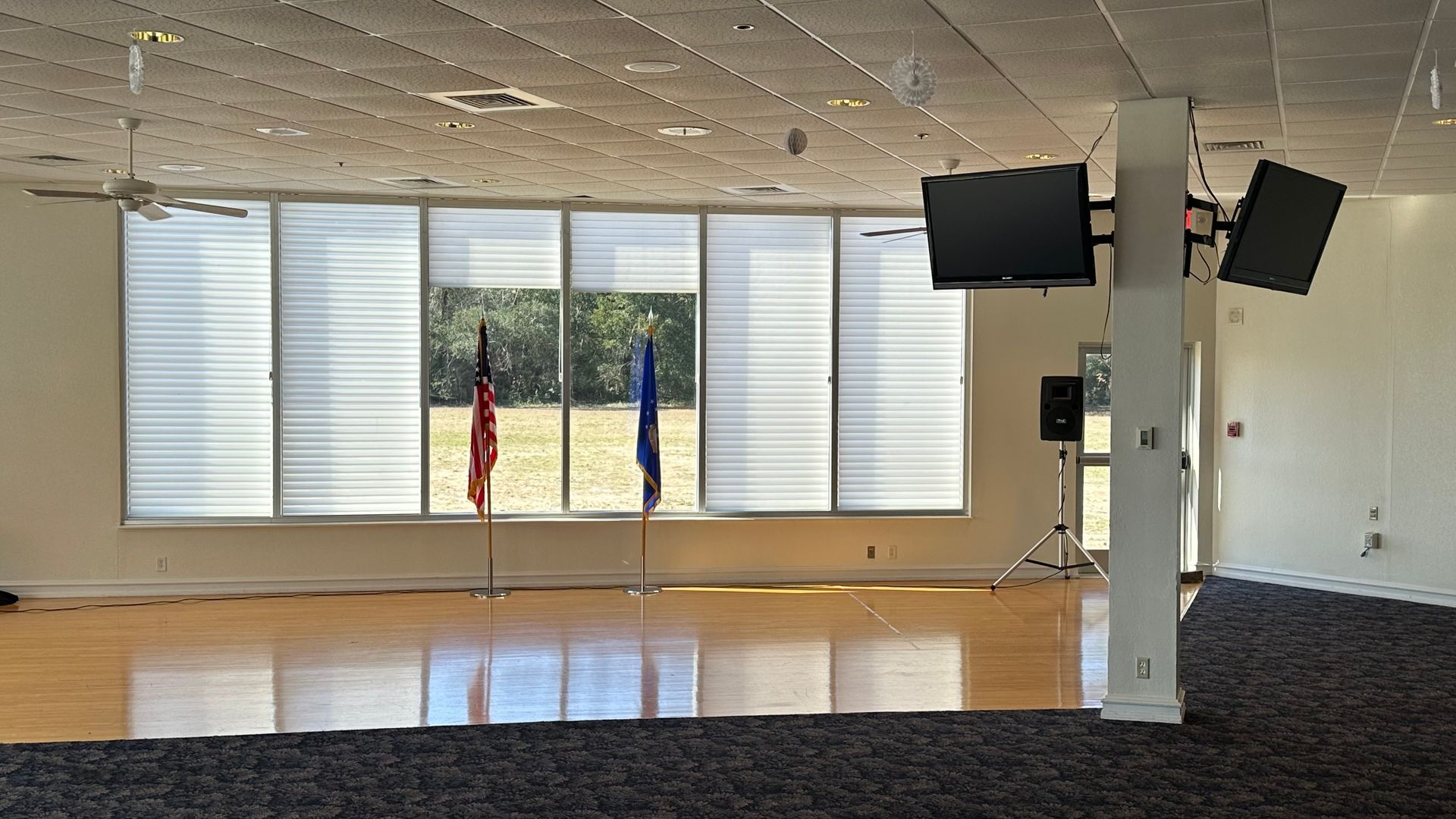 A large room with a lot of windows and flags - Crestview, FL - Sound Decision