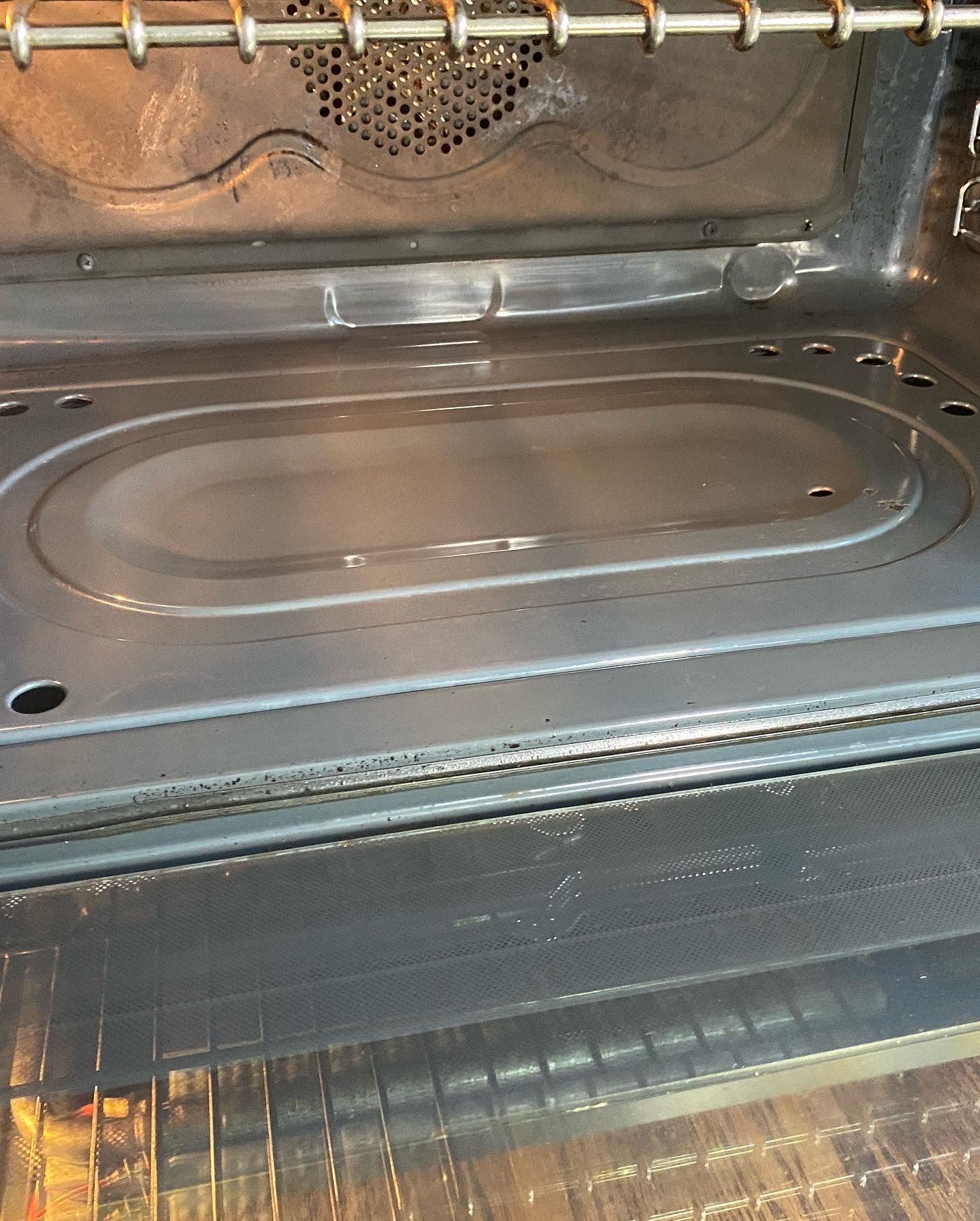 A close up of the inside of an oven with the door open