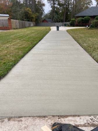 Freshly poured concrete driveway in a residential Addison, TX neighborhood