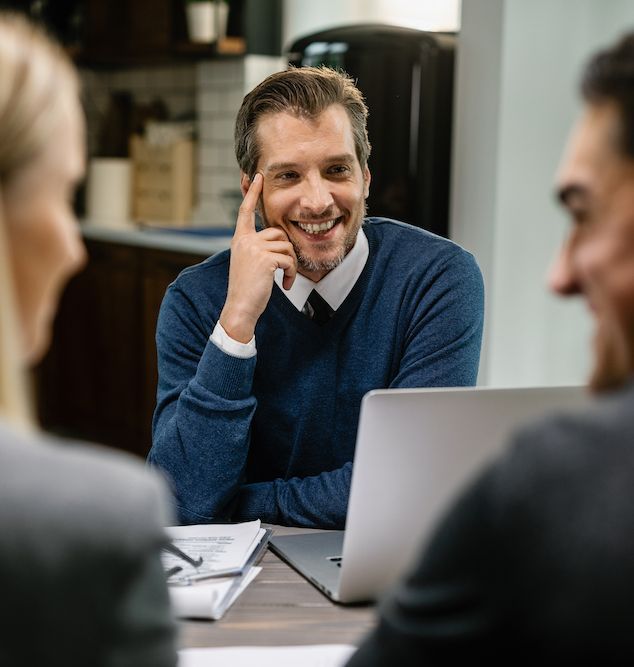 Experienced business advisor intently listening to clients during consultation and offering expert advice.