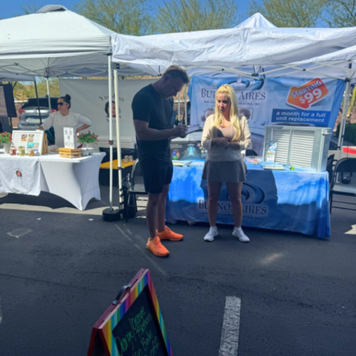 People at outdoor market stalls.