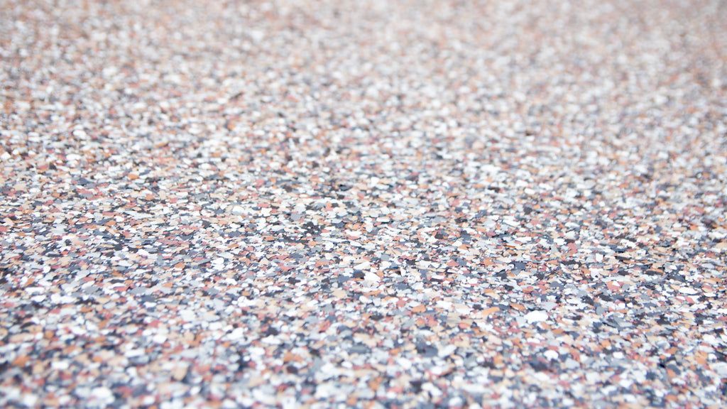 An epoxy resin flooring project in progress using multicolor vinyl flakes.