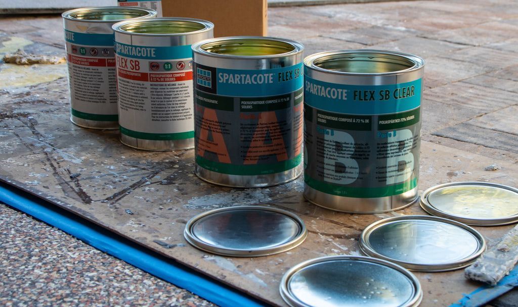 A set of epoxy resin mixture solutions lined up on a flooring project prepared for epoxy resin flooring installation.