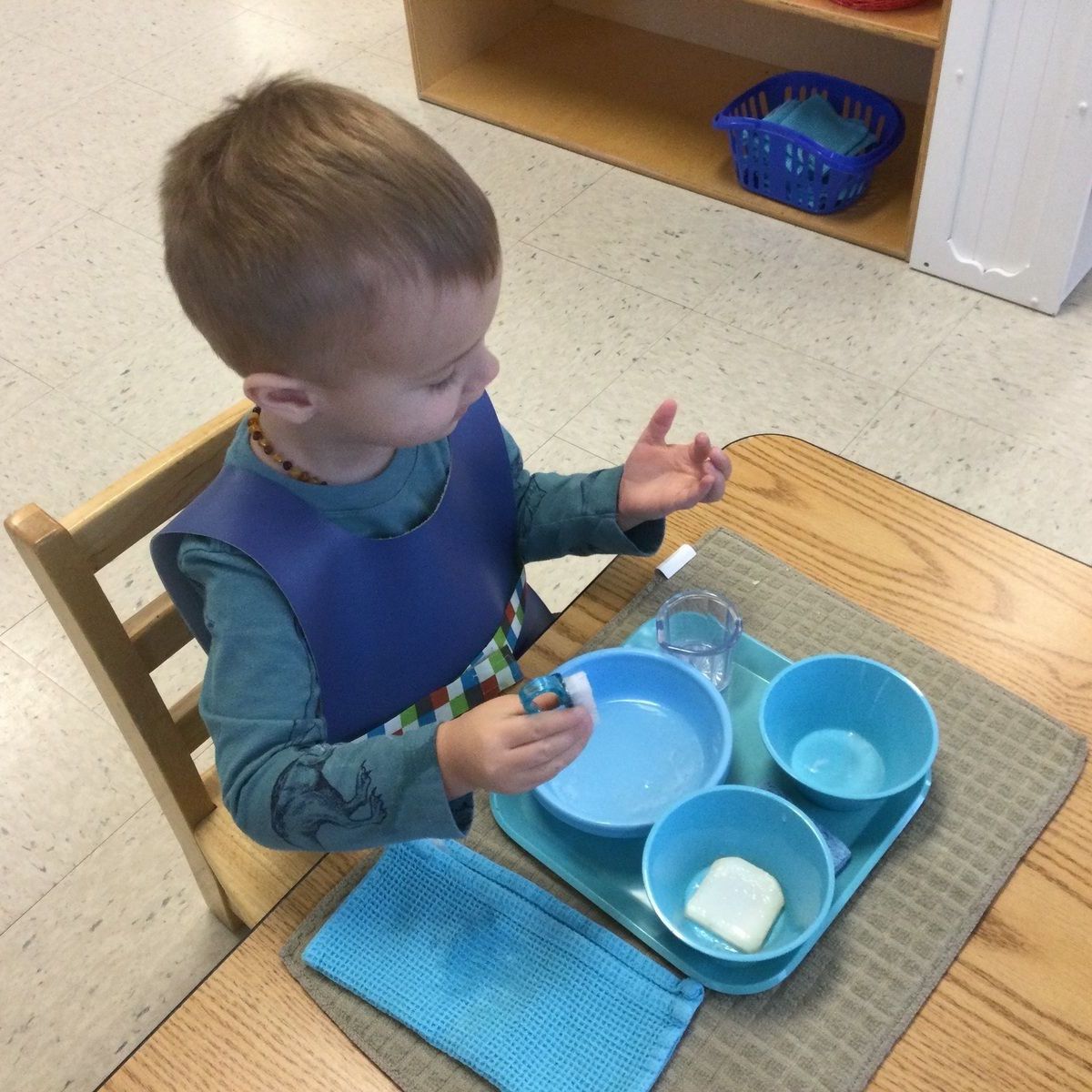 Montessori child working on practical life skills 