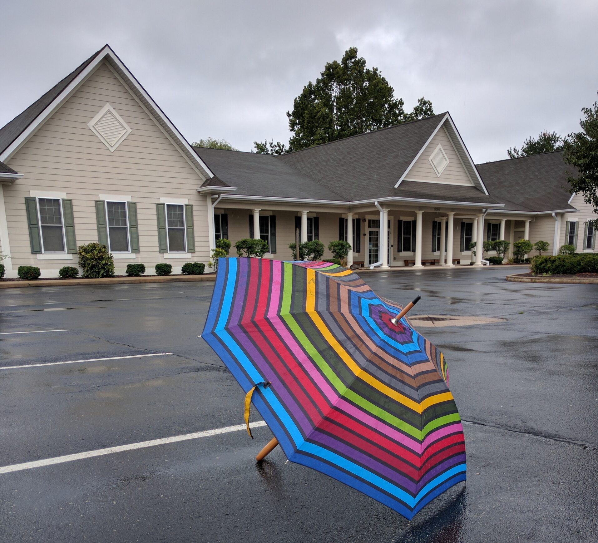 a colorful umbrella in front of Community Montessori School