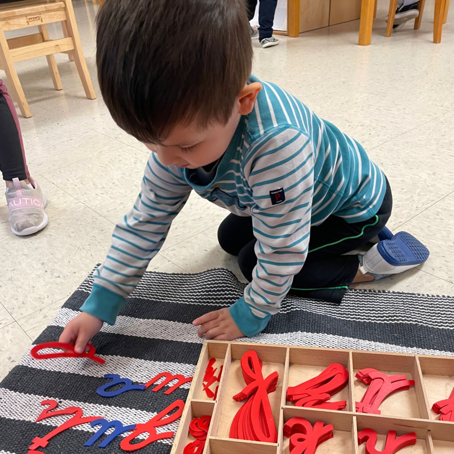 Montessori child working with language materials 