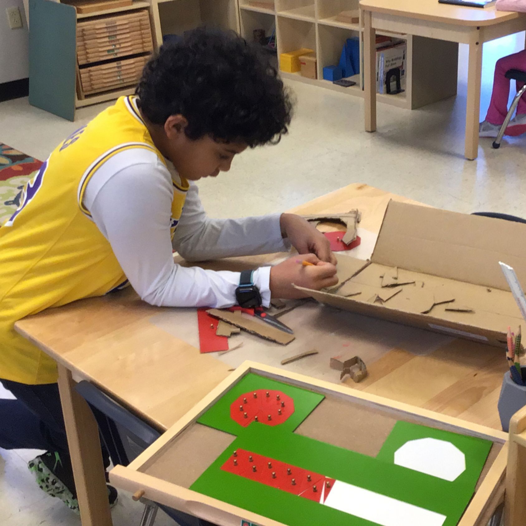 Montessori child working with math materials 