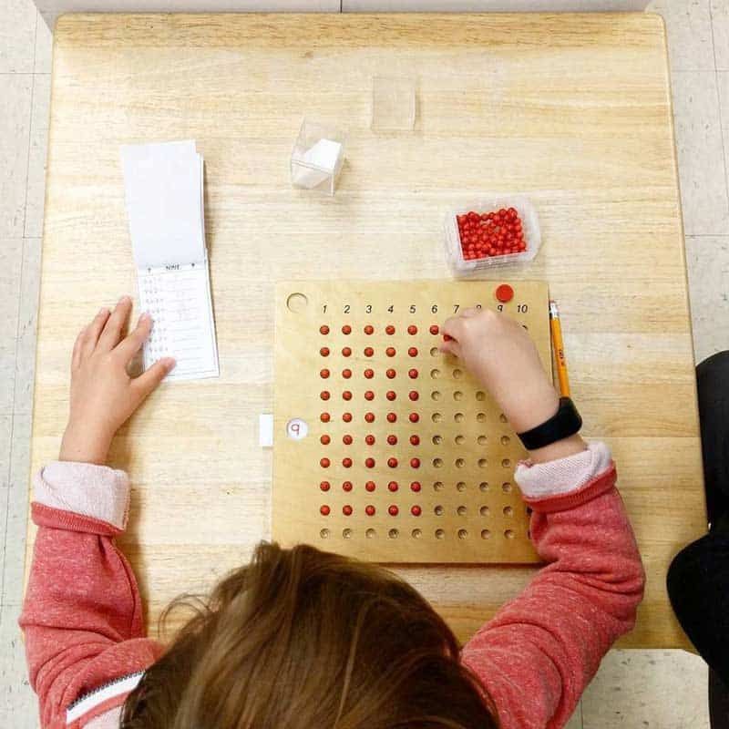 Montessori child working with math materials 