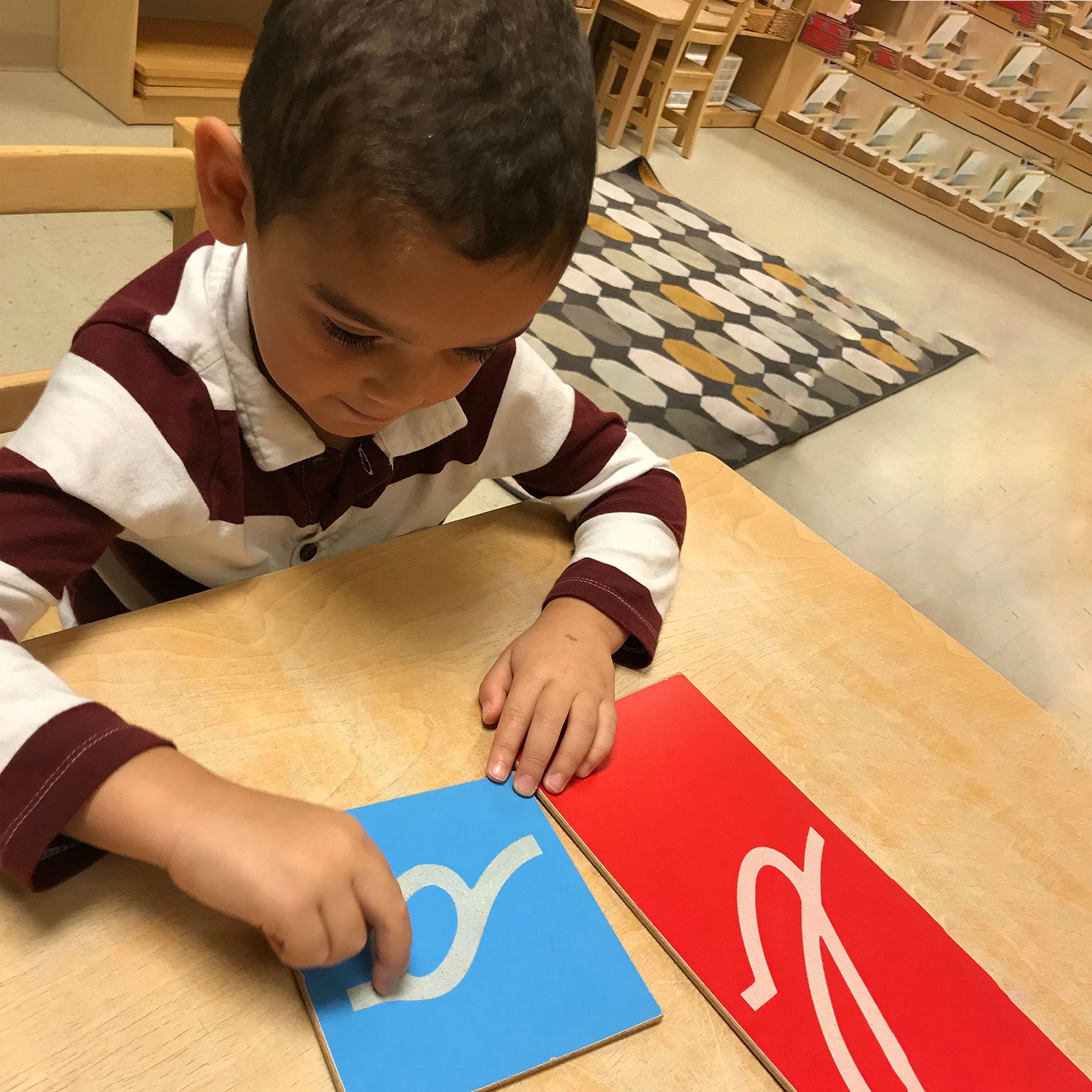 Montessori child is working with language materials