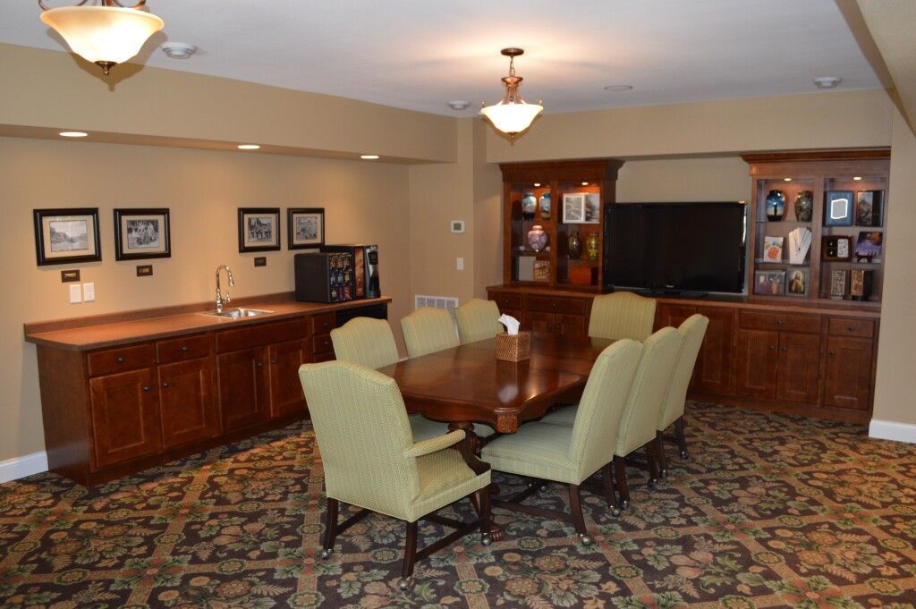 A dining room with a long table and chairs