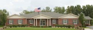 A large brick house with an american flag on top of it