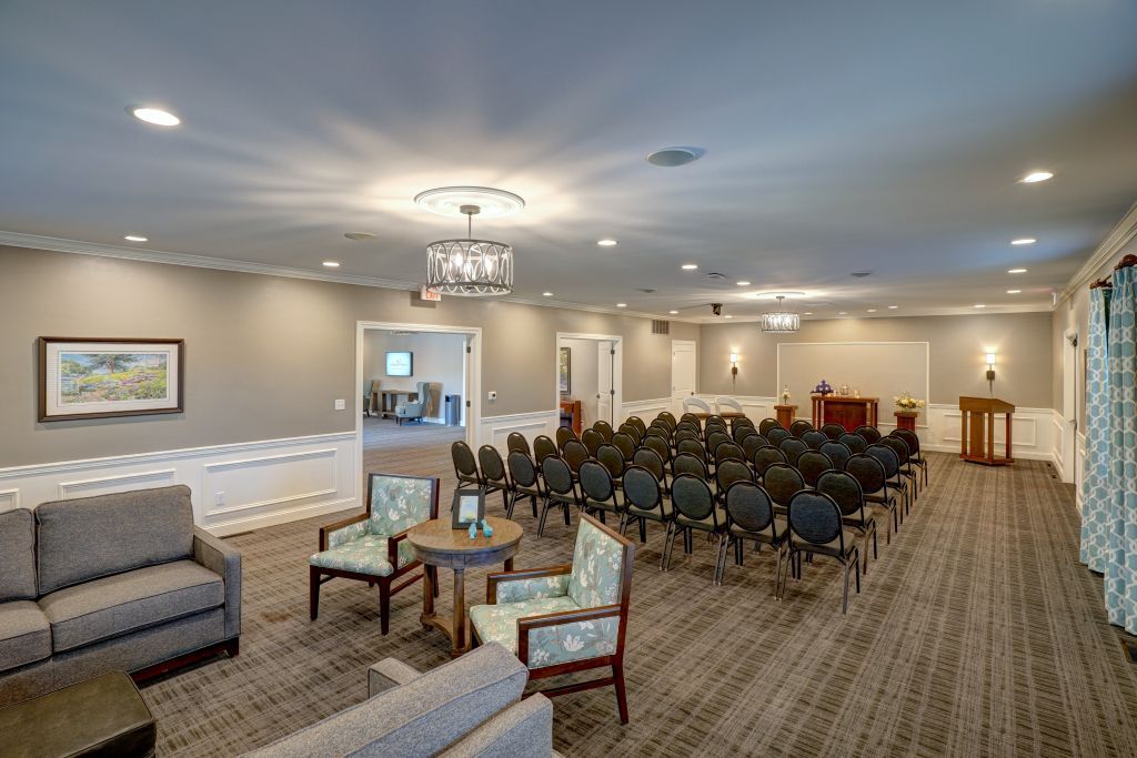 A large room with a lot of chairs and a couch.