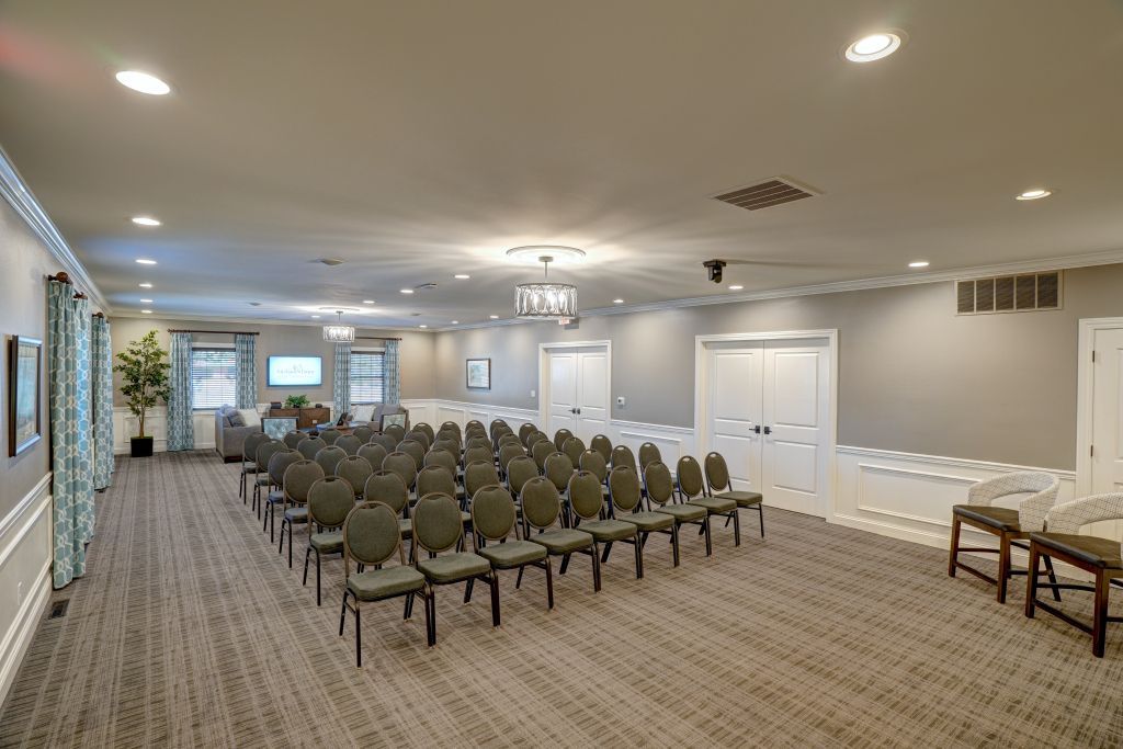 A large room with rows of chairs in it.