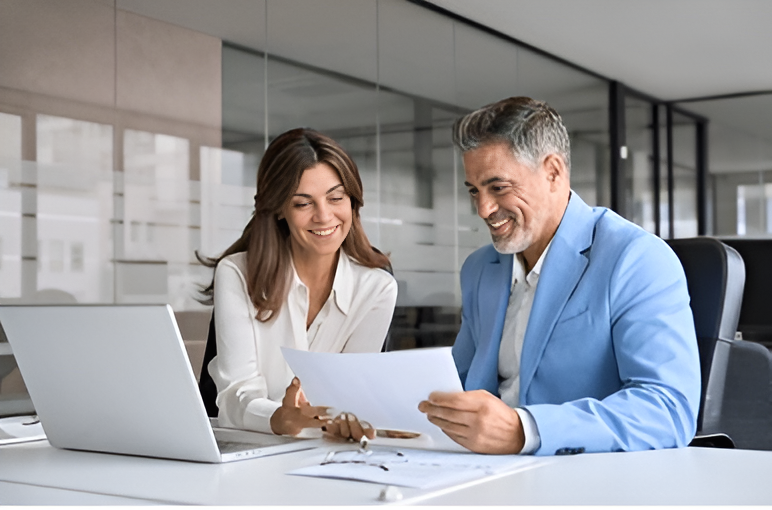 A man and a boy are sitting on a couch playing with a toy car.