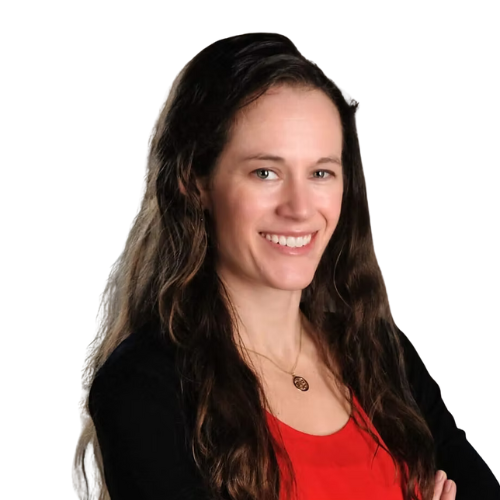Woman with long brown hair, smiling, wearing red shirt and black cardigan.