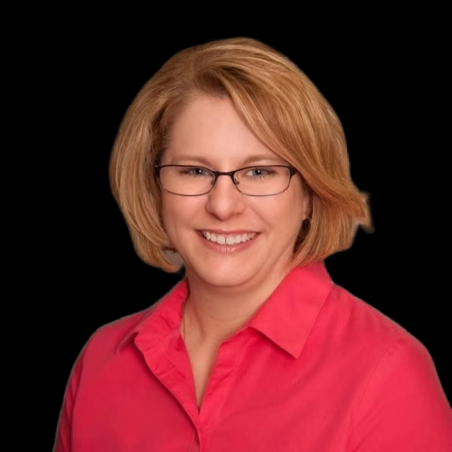 Woman with glasses and short blonde hair, smiling, wearing a pink shirt, against a black background.