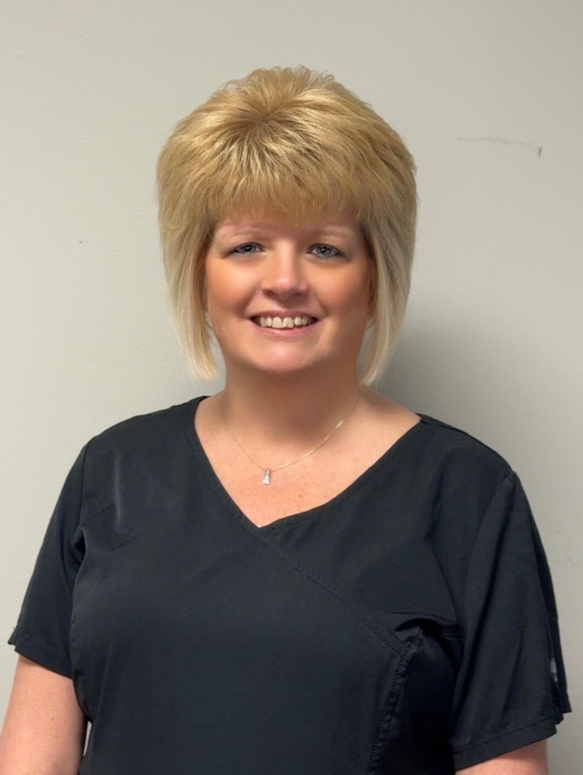 Black stylized eye with curved eyelashes and brow.