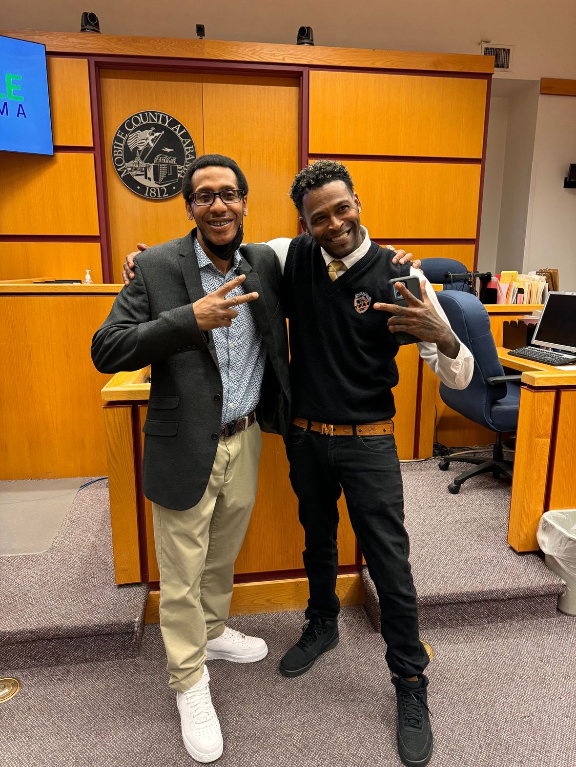 two clients standing and smiling