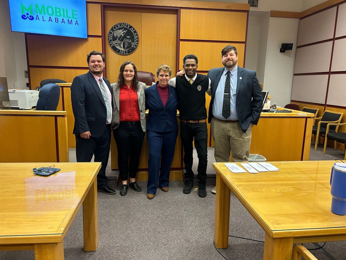 our attorneys standing and smiling with our clients