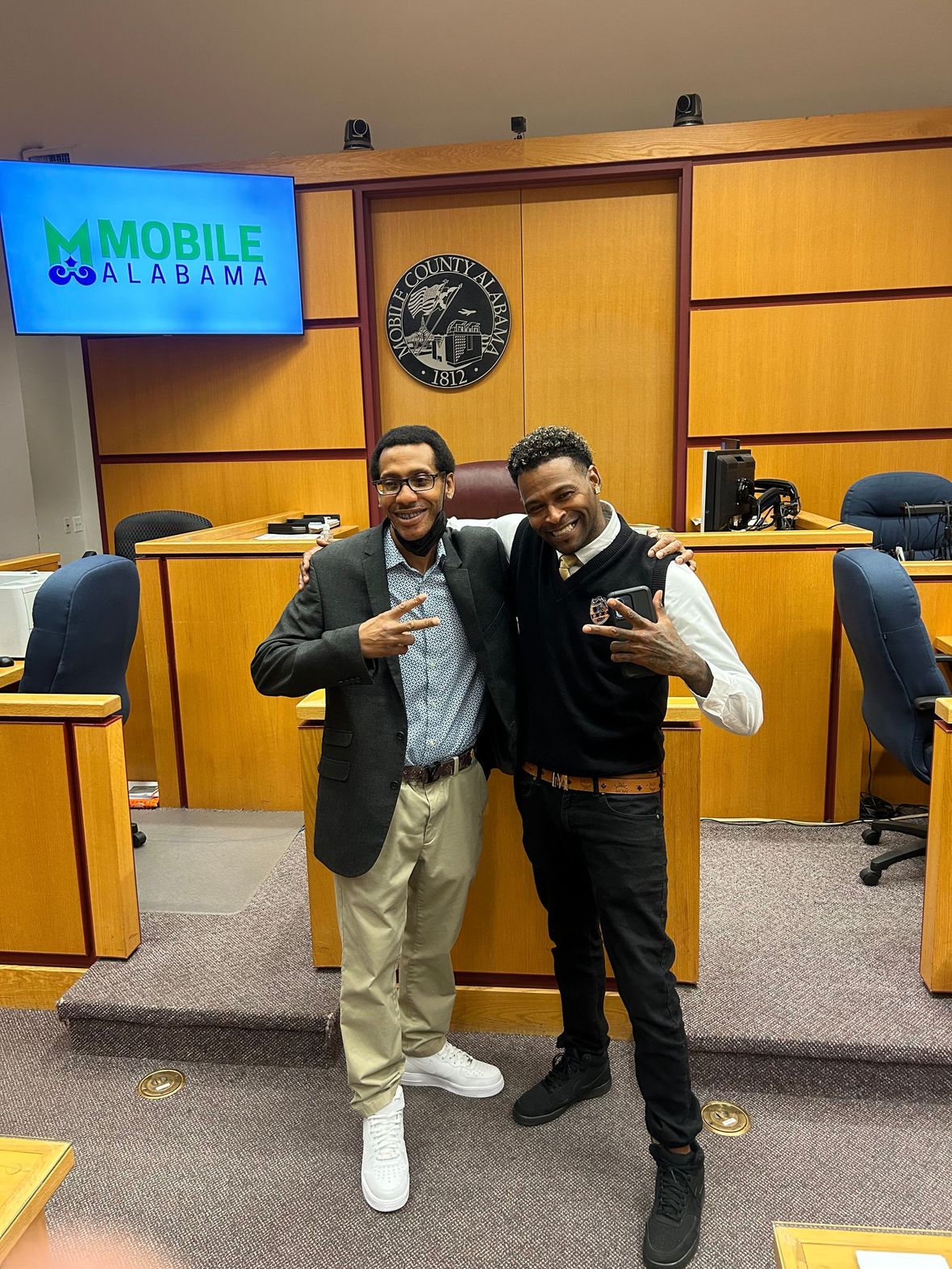 two clients standing and smiling