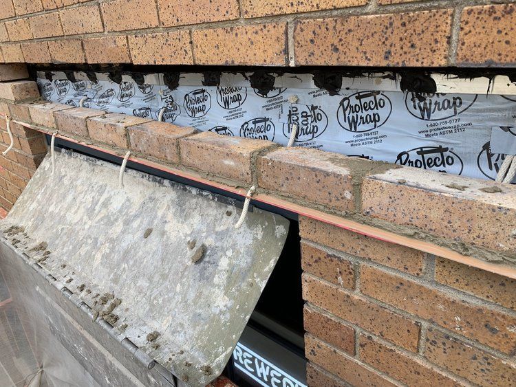 A brick wall with a piece of plastic covering it.