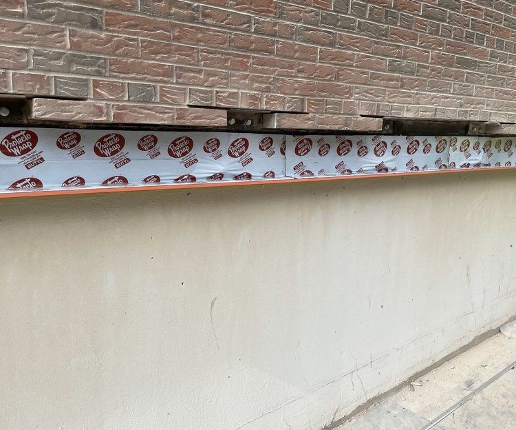 A brick wall with a lot of stickers on it