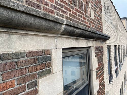 A brick building with a window on the side of it.