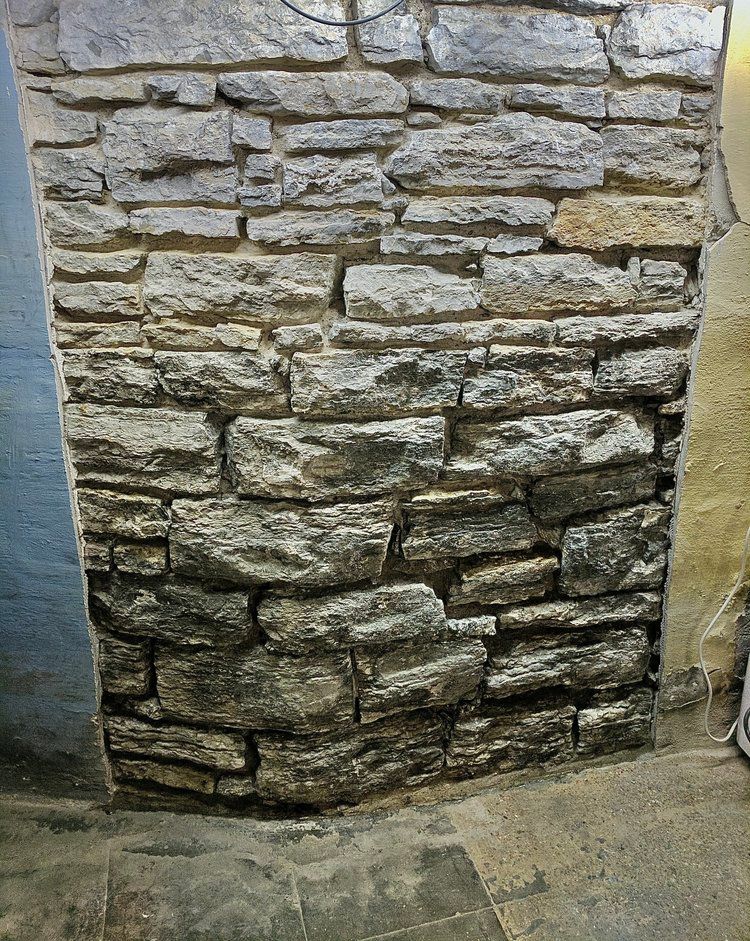 A close up of a stone wall in a room.
