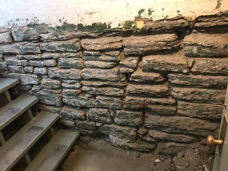 A stone wall with stairs leading up to it