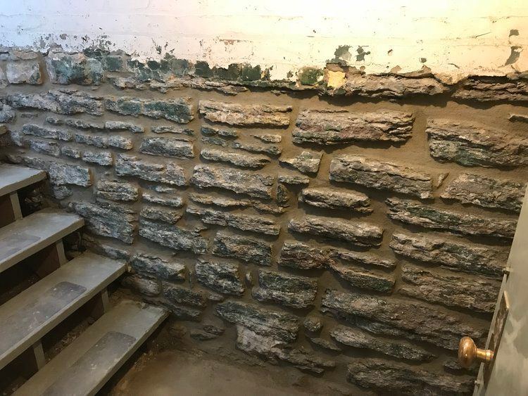 A stone wall with stairs leading up to it