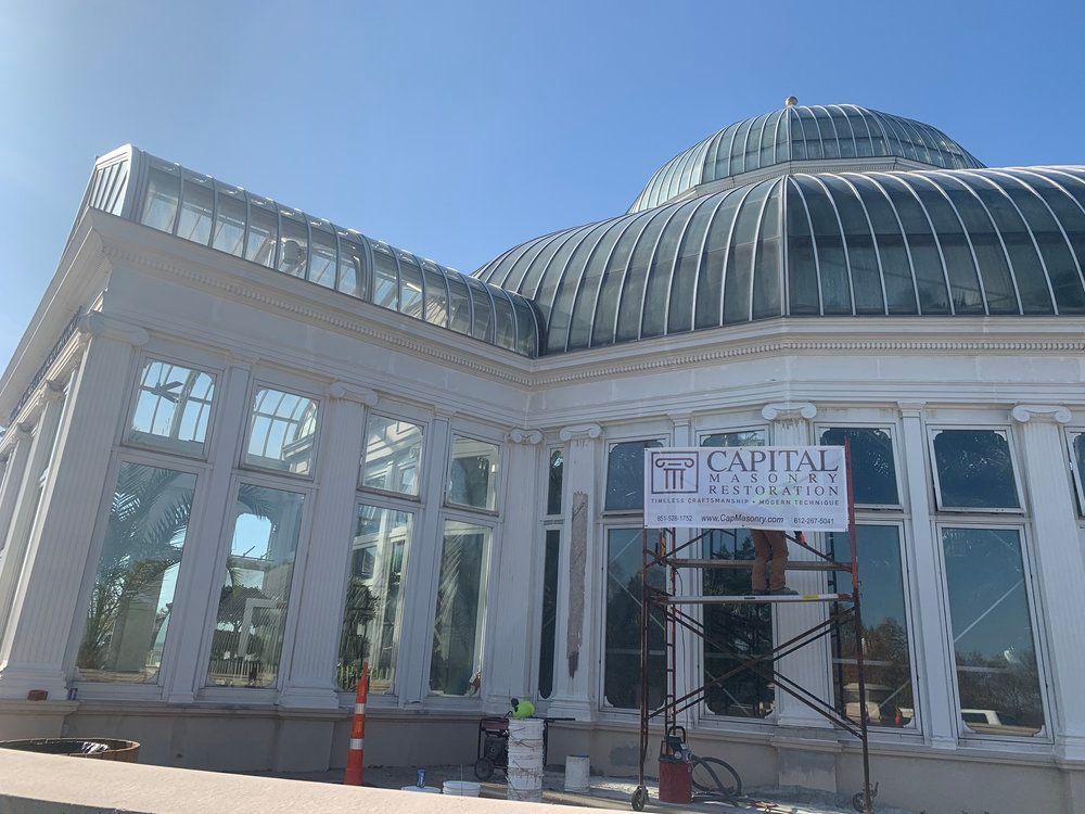 A large building with a dome roof is being remodeled.